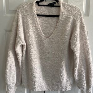 Off-white color revolve sweater.